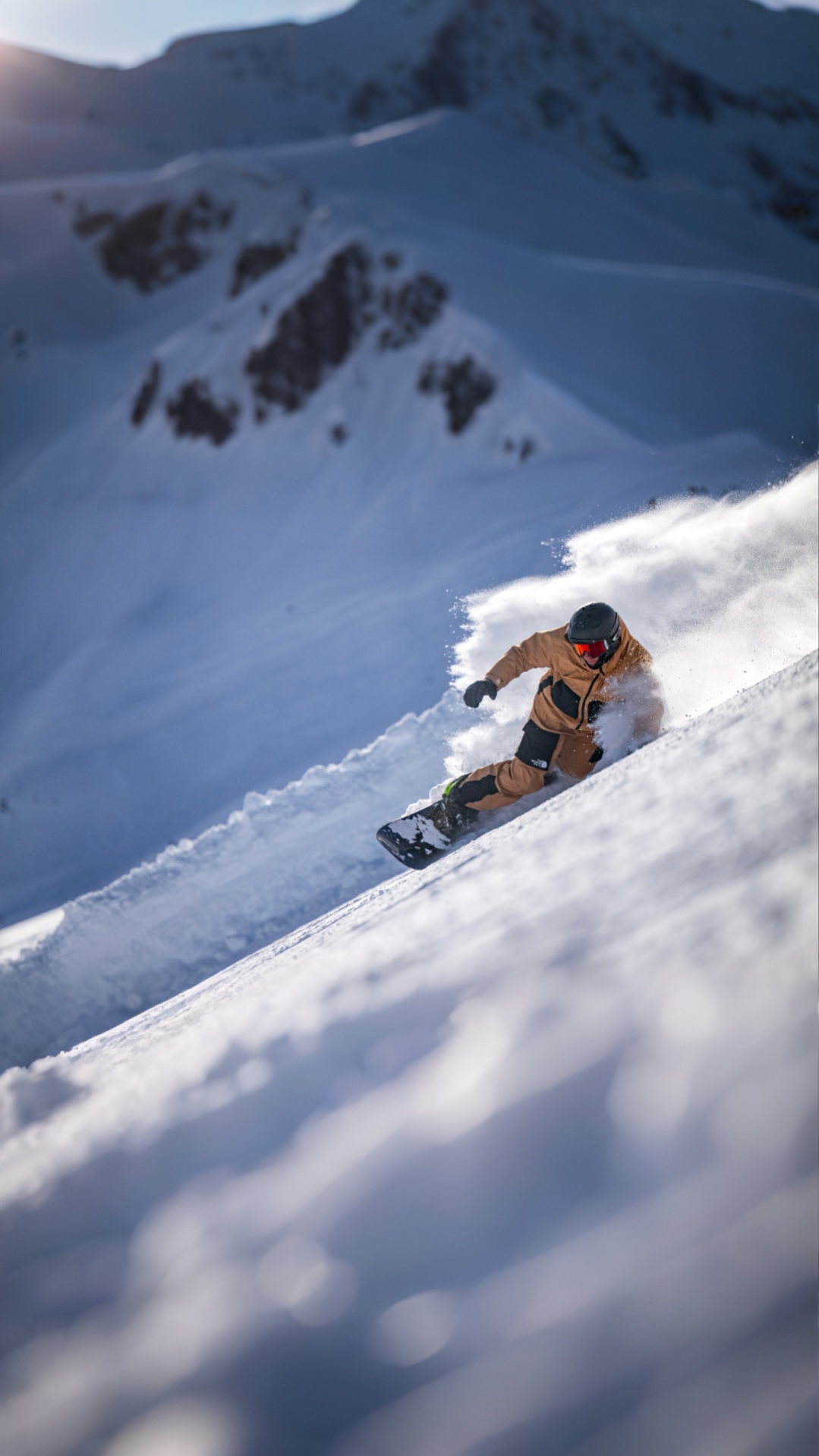 Snowboarder carving powder